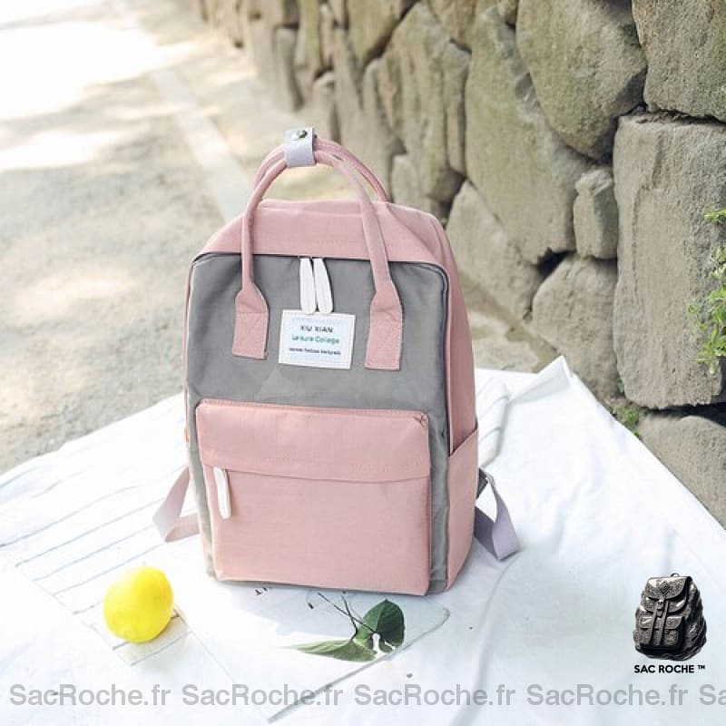 Sac à dos en toile pour ordinateur 15 pouces gris et rose avec un fond, un mur en pierre