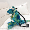 Sac à dos original dinosaure 3D vert avec un fond un lit blanc