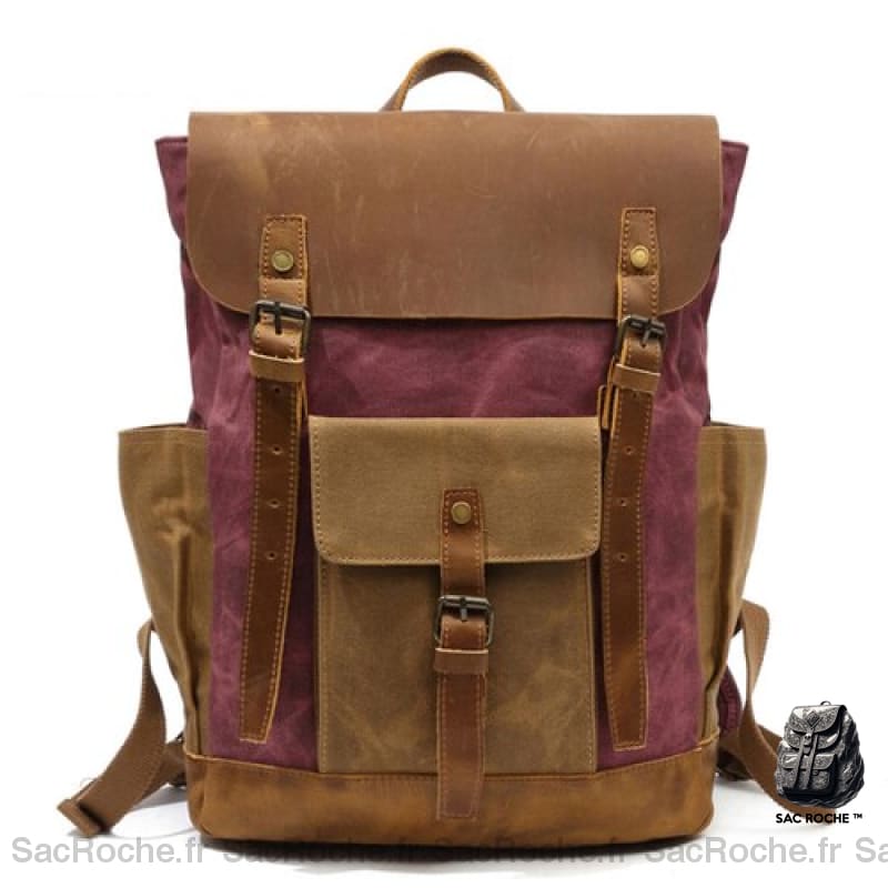 Sac à dos vintage en toile de cire marron et rose avec un fond blanc