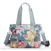 Sac à main à motif floral pour femme multicolore bleu avec un fond blanc